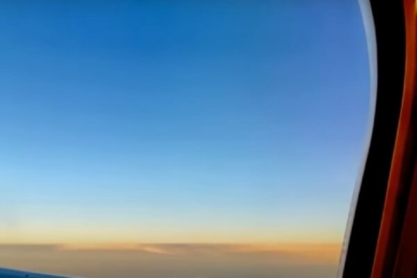 Watch Video UFO flying along with the plane recorded in passenger camera